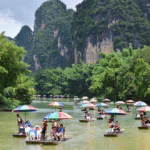 People enjoy rafting on Yulong River in Yangshuo County, Guilin City, south China's Guangxi Zhuang Autonomous Region, Aug. 2, 2026. (Photo by Liao Zuping/Xinhua)