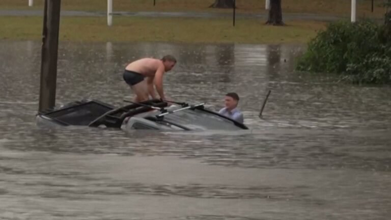 Australian TV reporter rescues man from sinking car